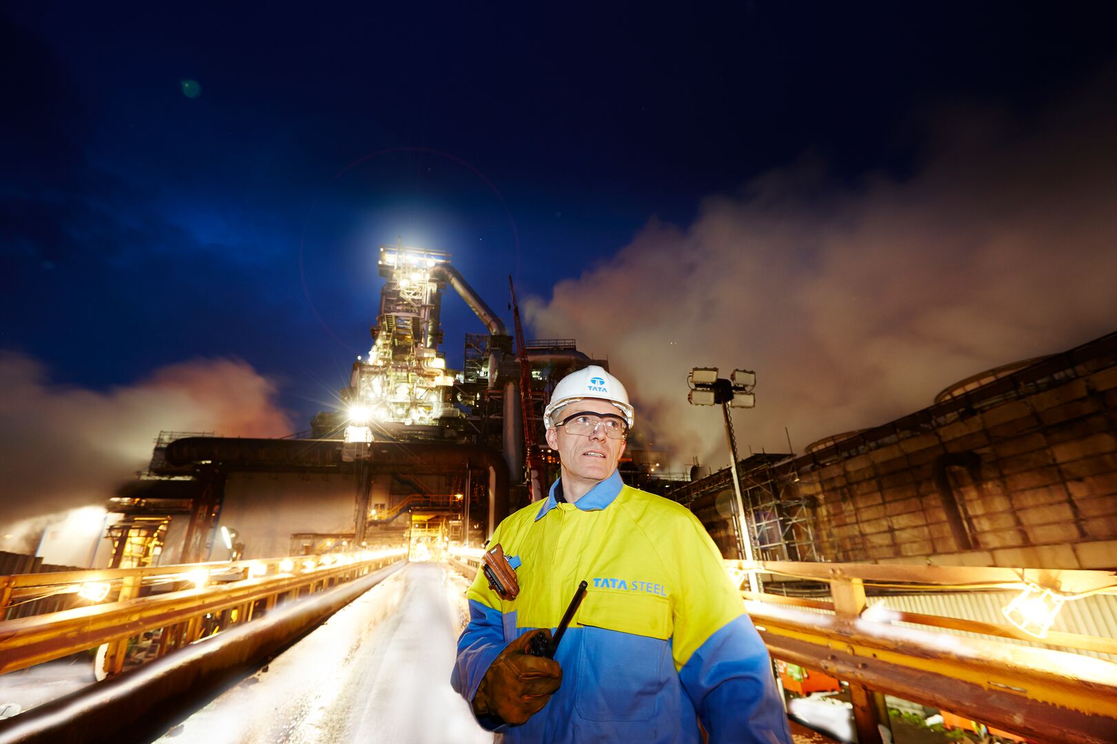 Tata Steel employee at Port Talbot site with blast furnace in the background Tata Steel employee at Port Talbot site with blast furnace in the background