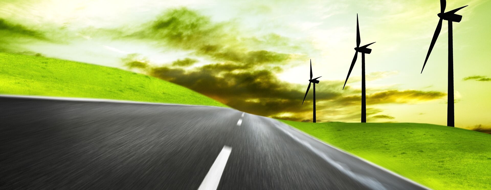 Open road with windmills in the background