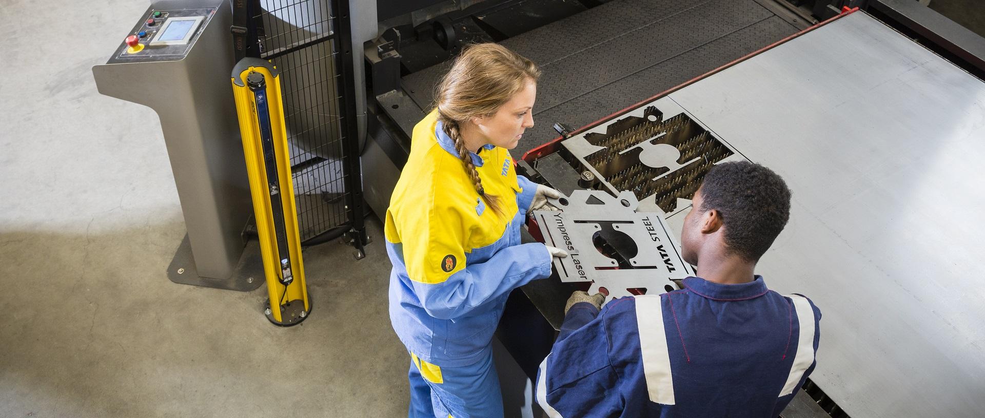 Metal workers looking at Ympress Laser cuts