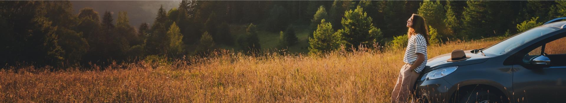 Woman enjoying car stop in nature