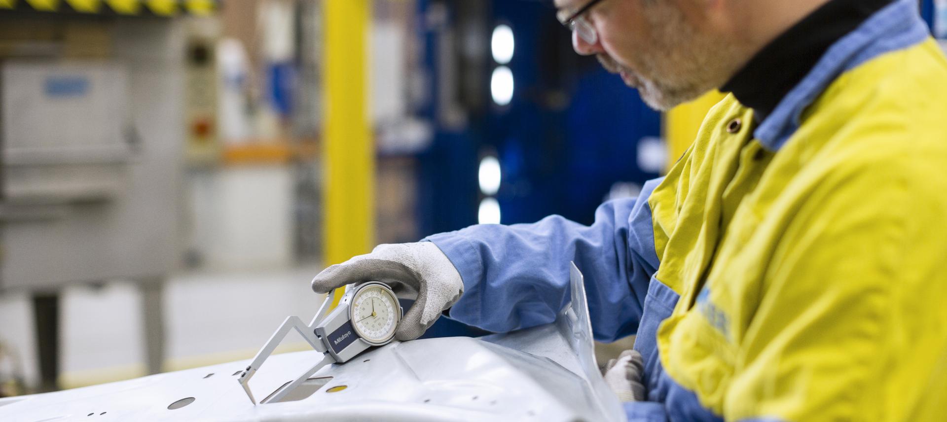 Tata Steel researcher carrying out tests on a piece of steel Tata Steel researcher carrying out tests on a piece of steel