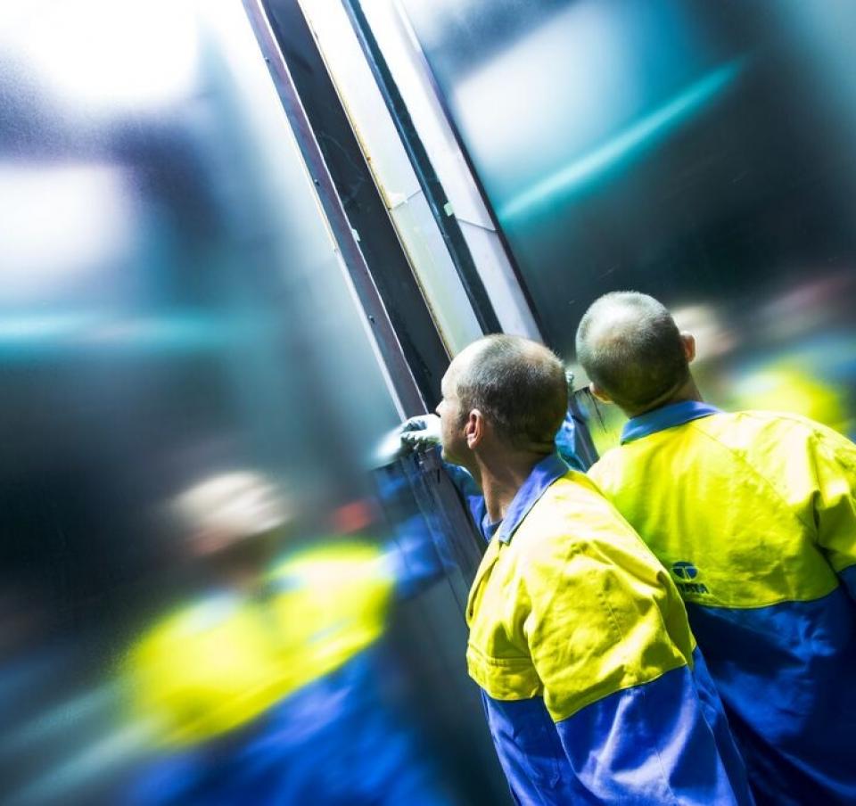 Tata Steel employee in high viz jacket checking steel Tata Steel employee in high viz jacket checking steel