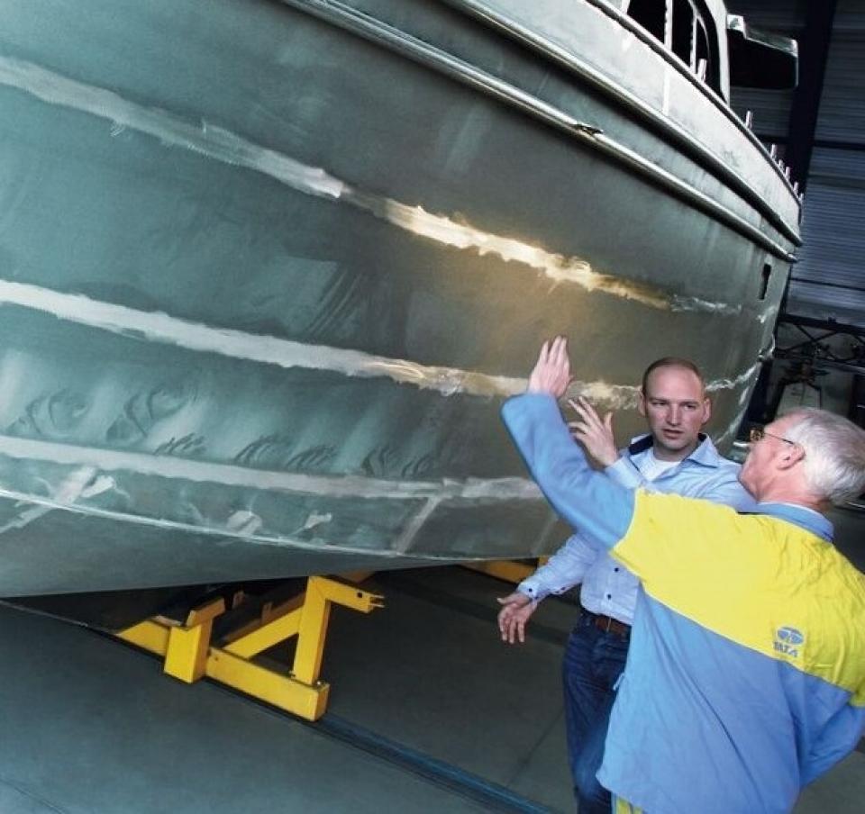 Tata Steel and Linssen workers reviewing the bottom panel of a yacht Tata Steel and Linssen workers reviewing the bottom panel of a yacht