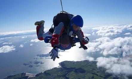 Woman jumping out of a plane with a parachute Woman jumping out of a plane with a parachute